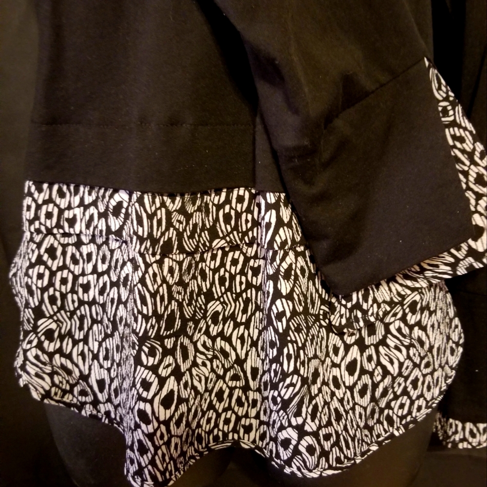 Michael Kors black top with bottom detail.